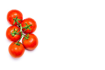 Overhead shot of five wet red natural tomatoes on a white background.The photo has copy space and is shot in horizontal format.