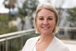 © Wavebreak Media - Portrait of smiling caucasian female business creative looking at camera outside workplace