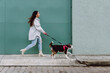 © ADDICTIVE STOCK - Woman running with dog along street