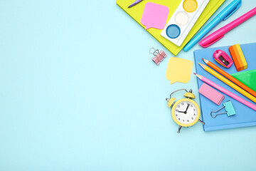 Wall Mural - School supplies with alarm clock on blue background