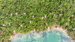 Aerial view of an amazing village with bungalows and treehouses on a paradise beach