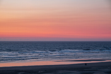 Wall Mural - Haystack rocks silhouette against colorful sunset evenings on the beach