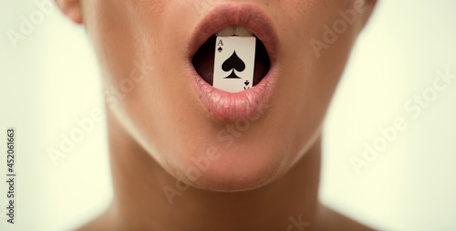 Beauty playing strip poker. Poker face. Casino. Background. Woman lips.