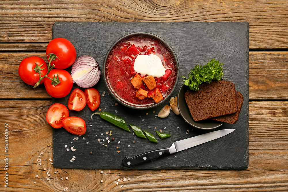 Composition with tasty borscht on wooden background