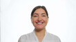© lenblr - Nice young woman with dark hair wearing trendy white shirt smiles gently posing for camera on professional studio background close view