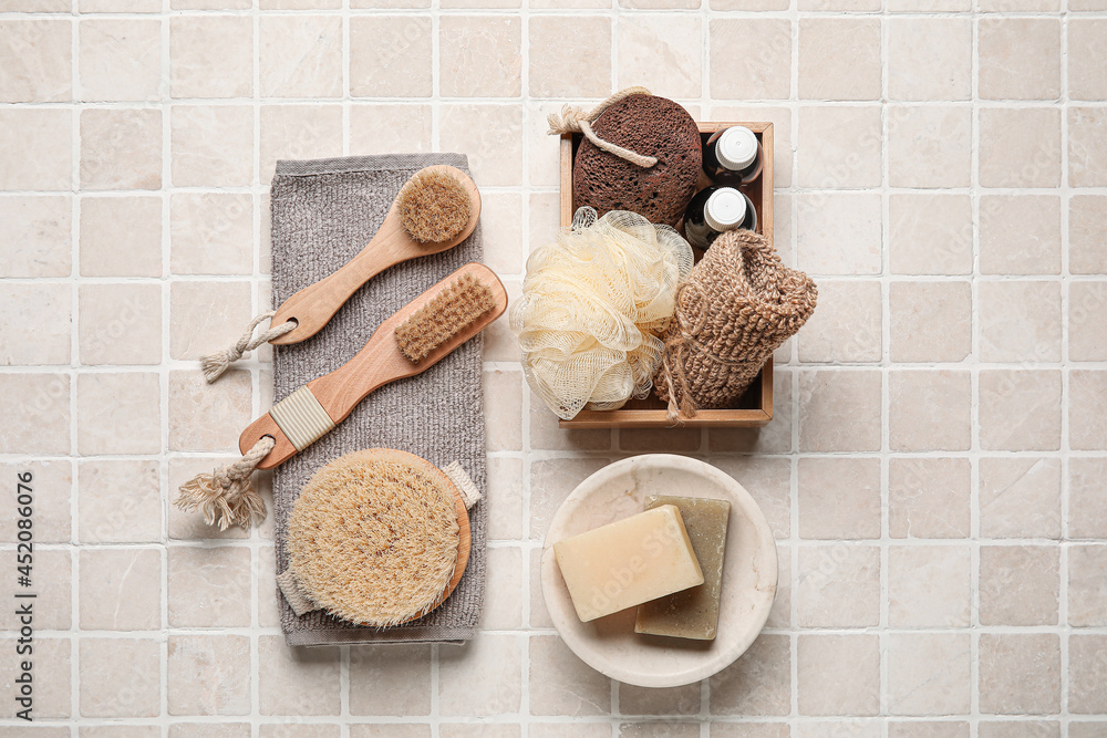 Composition with different body brushes on light tile background