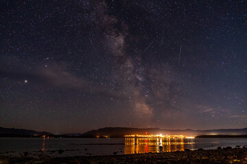 Wall Mural - night view to small town at Mount Waddington many stars on dark sky.