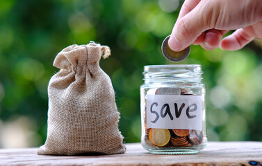 Sticker - Coins in jar on green background and saving money and business growth concept,finance and investment concept, Growth money of profitability of professional investment.