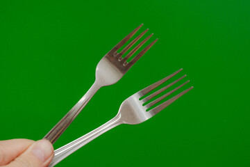 hand holds two kitchen forks