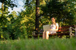 © Maksym - Computer outdoor. Student girl working on laptop, tablet in summer park. Woman person business nature outside with online technology. Electronic gadgets distance learning concept.