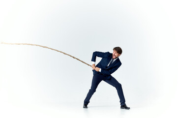 Poster - business man in suit pulling rope Studio team work