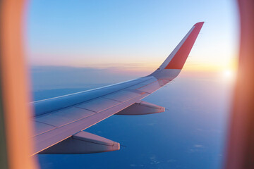 Wall Mural - wing airplane by airplane window frame, travel, freedom. selective focus
