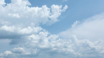Wall Mural - 4k video time lapse of scenic sunny peaceful cloudscape. many fluffy white clouds changing and movin