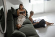© rh2010 - Lesbian couple having a leisure time with book and touchpad together on the couch at home. Homosexual relations and comfort living concept