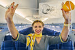© Svitlana - Friendly air hostess demonstrating a breathing apparatus