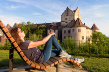 Young Woman Tourist Rests At Meersburg Castle, Germany