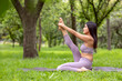 © Edgar1 BJ - Latin woman doing Yoga-asanas with different postures, in the outdoor park with grass and trees in the background