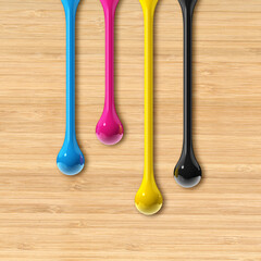 Wall Mural - cmyk ink drops on beige wooden square background