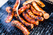 Closeup Shot Of Grilling Sausages On A Barbecue Grill