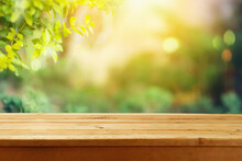 Empty Wooden  Table Over Blurred Nature Background.  Outdoor Picnic Mock Up For Design And Product Display.