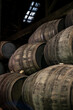 Old porto lodge with rows of oak wooden casks for slow aging of fortified ruby or tawny porto wine in Vila Nova de Gaia, Portugal