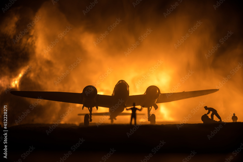 German Junker (Ju-88) night bomber at night. Artwork decoration with scale model of jet-propelled plane in possession. Toned foggy background with light. War scene. - obrazy, fototapety, plakaty 