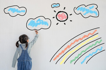 Wall Mural - The child paints a rainbow on wall of the quarantine introduced due to coronavirus as a symbol of hope for the end of the coronavirus pandemic. Children's drawing of a rainbow