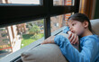 © David Pereiras - Girl looking out the window sad because she can't get out