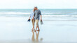 Asian Lifestyle senior couple walking chill on the beach happy in love romantic and relax time after retirement.  People tourism elderly family travel leisure and activity after retirement