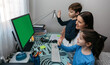 © David Pereiras - Mother and children waving on video call with computer