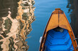 Venetian boat on a canal in Venice with reflective water