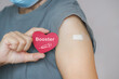 senior woman show red heart shape with syringe icon,  after vaccinated or inoculation  booster dose  due to spread of corona virus, population, social or herd immunity concept
