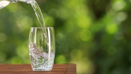 Canvas Print - pouring drinking water from jug into glass