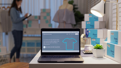 UX UI smart website notebook screen on desk table home office designer studio e-commerce salepage media startup sme with asia busy woman female worker work supply chain logistic delivery wifi network.