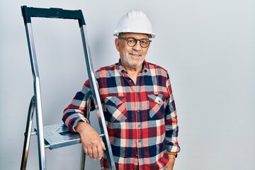 Sticker - Handsome mature handyman close to construction stairs wearing hardhat with a happy and cool smile on face. lucky person.