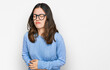 © Krakenimages.com - Young beautiful woman wearing casual clothes and glasses with hand on stomach because indigestion, painful illness feeling unwell. ache concept.