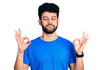 © Krakenimages.com - Young arab man with beard wearing casual blue t shirt relaxed and smiling with eyes closed doing meditation gesture with fingers. yoga concept.