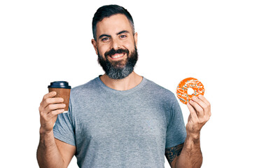 Hispanic man with beard eating doughnut and drinking coffee smiling with a happy and cool smile on face. showing teeth.