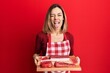 © Krakenimages.com - Young caucasian blonde woman holding board with raw meat sticking tongue out happy with funny expression.