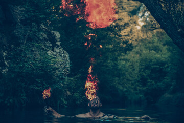 Wall Mural - Man in a river blowing fire