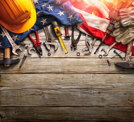 labor day - national holiday - mechanic tools and usa flag on wooden background
