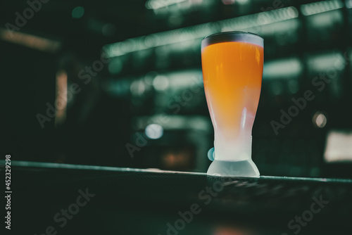 glass of light beer stand on bar counter in a bar or pub