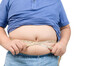 Obese boy measures his fat belly with a measuring tape isolated on white