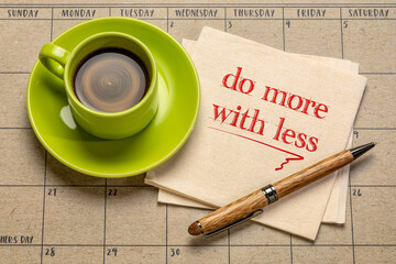 Wall Mural - do more with less motivational note on napkin with a cup of coffee, productivity, smart work, business, education and personal development concept