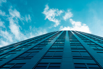 Wall Mural - downtown high-rise skyscraper office building with cloudy blue sky
