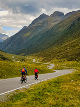 Two cyclists descent from the serpentine road over the Silvretta-pass, Tirol, Austria.
