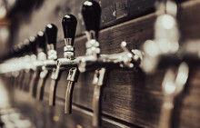 Many Beer Taps In Bar Or Pub. Tap Room