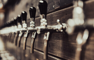 many beer taps in bar or pub. tap room