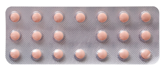 pink pills in a silver opaque plate isolated on a white background.