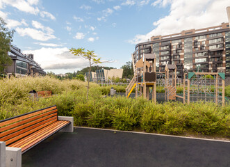 Wall Mural - Recreation bench and children playground house building facade mixed-use urban multi-family residential area settings